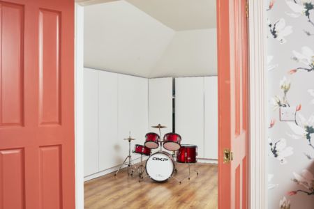 Loft room with storage,doorway,timber flooring,slanted ceiling,wallpaper